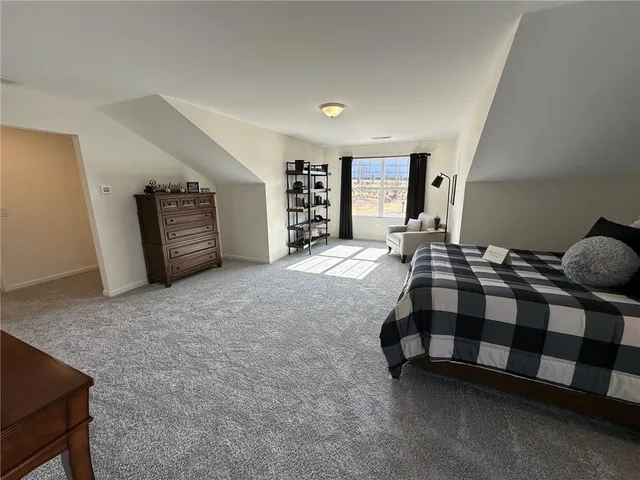 a spacious bedroom with a bed and ceiling fan