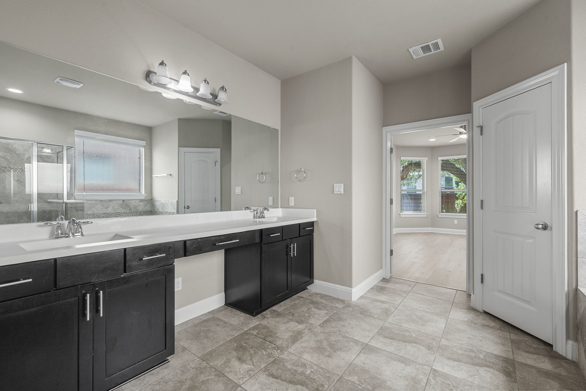 4401 Trinity Woods Street Leander, TX 78641 - Photo 20 of 37 Dual vanities and a spacious layout create a highly functional primary bathroom.