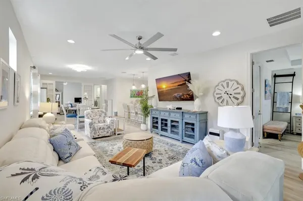 a living room with furniture a large window and a flat screen tv