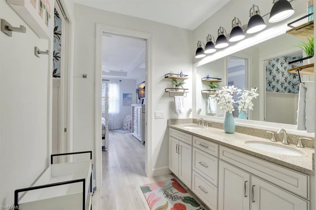 20183 Torch Key Way Estero, FL 33928 - Photo 12 of 30 Full bath featuring double vanity, connected bathroom, and light wood-type flooring