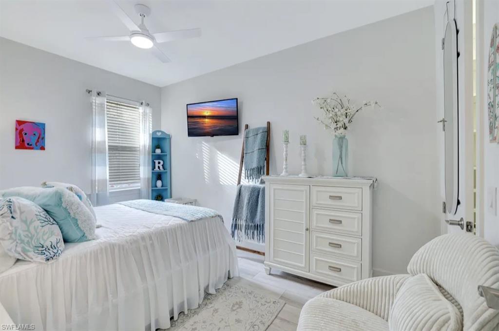 20183 Torch Key Way Estero, FL 33928 - Photo 13 of 30 Bedroom with ceiling fan and wood finished floors
