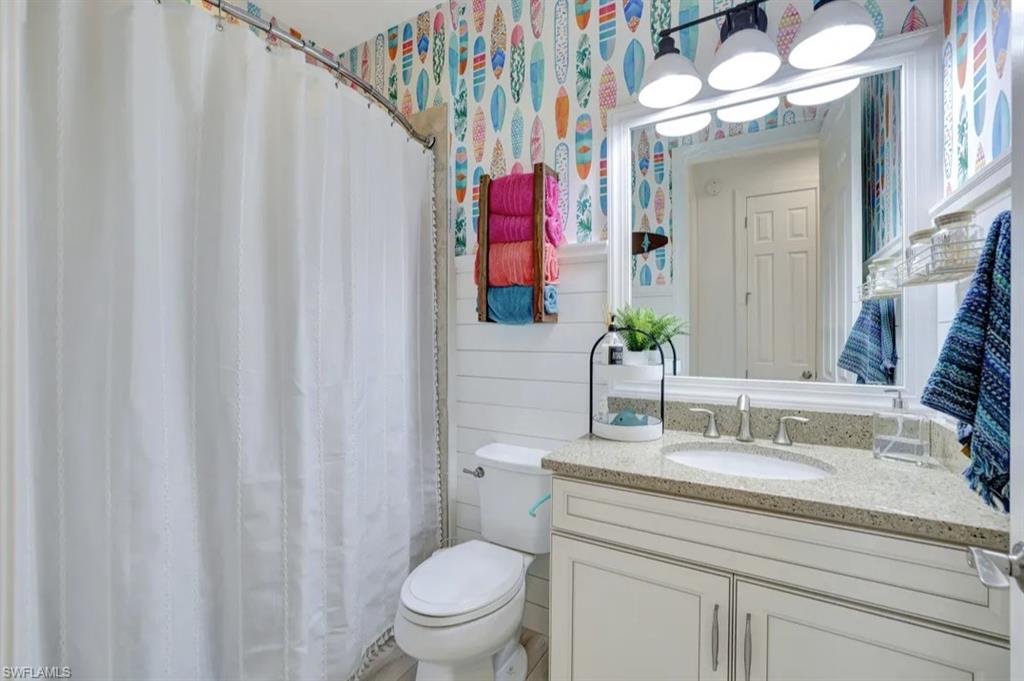 20183 Torch Key Way Estero, FL 33928 - Photo 14 of 30 Full bathroom with tub, featuring curtained shower and vanity