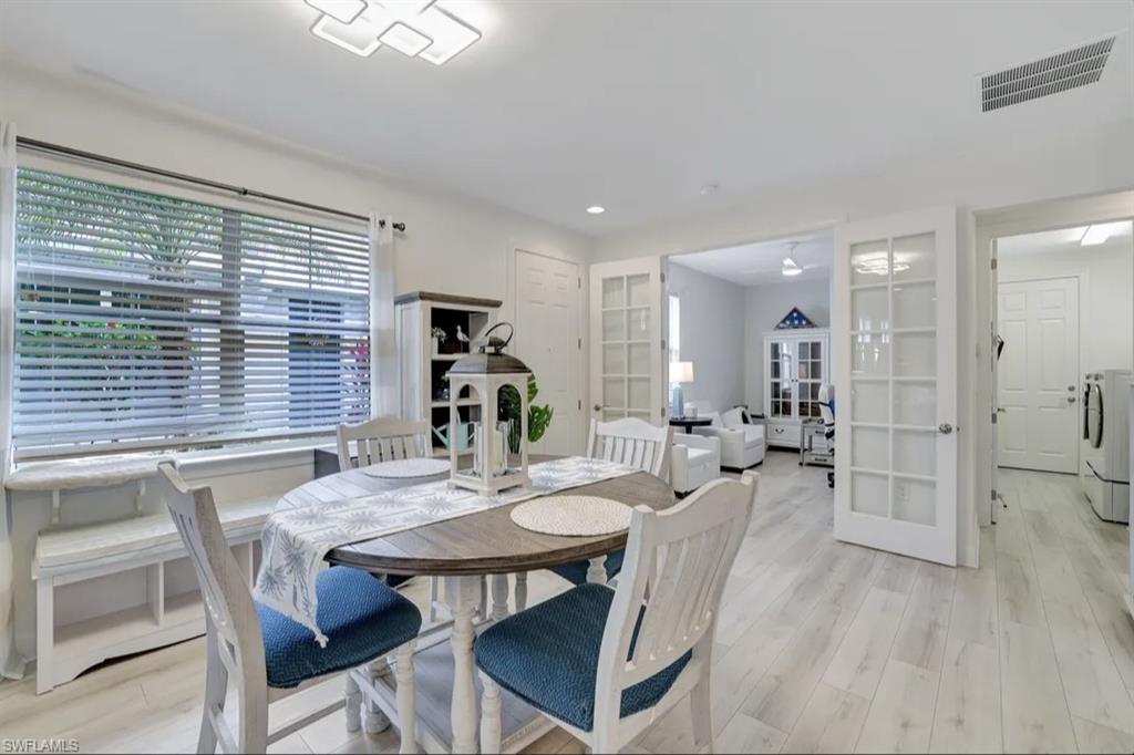20183 Torch Key Way Estero, FL 33928 - Photo 7 of 30 Dining room with light wood-style floors, washing machine and clothes dryer, and recessed lighting