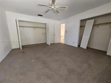a view of empty room with ceiling fan