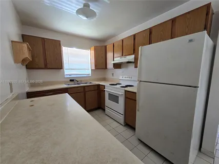 a kitchen with stainless steel appliances a refrigerator sink and microwave