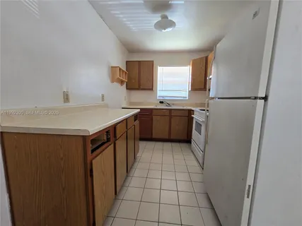 a kitchen with a sink appliances and cabinets