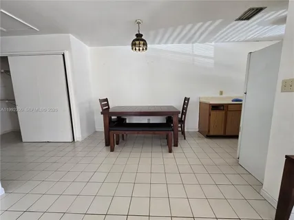 a view of kitchen with furniture and refrigerator