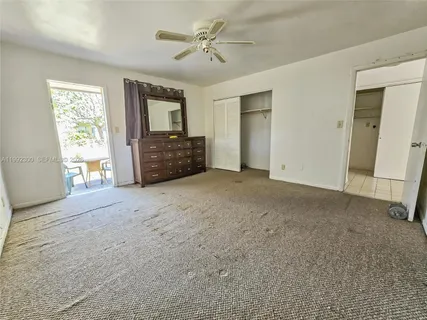 a big room with closet and a chandelier fan