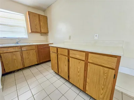 a view of a kitchen with white cabinets