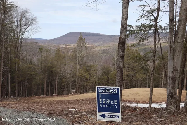 a view of a wooden fence next to a road