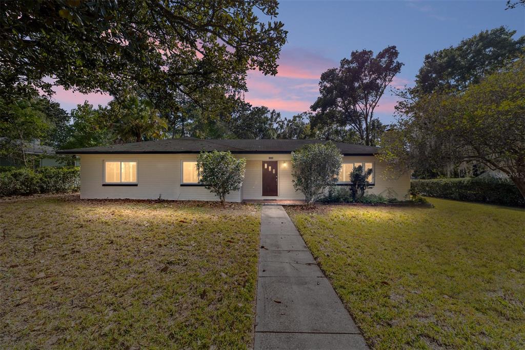1523 Northwest 11th Road Gainesville, FL 32605 - Photo 1 of 1 a front view of a house with a yard and trees