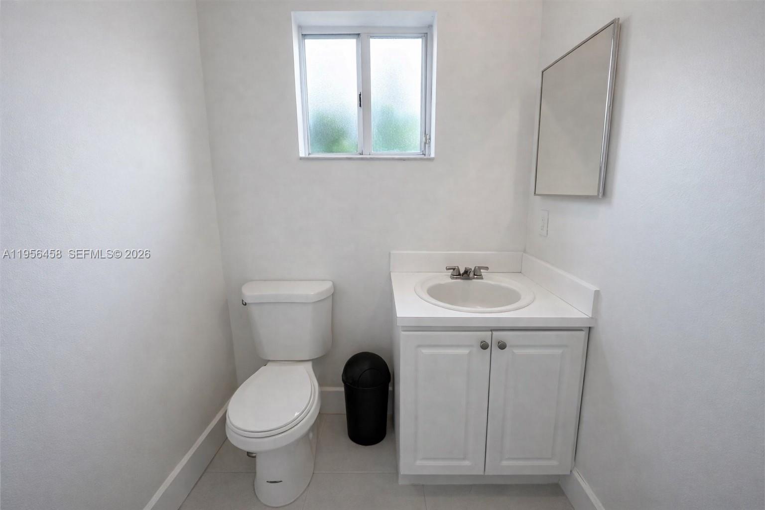 841 Southwest 6th Street Florida City, FL 33034 - Photo 4 of 5 a bathroom with a toilet sink and mirror