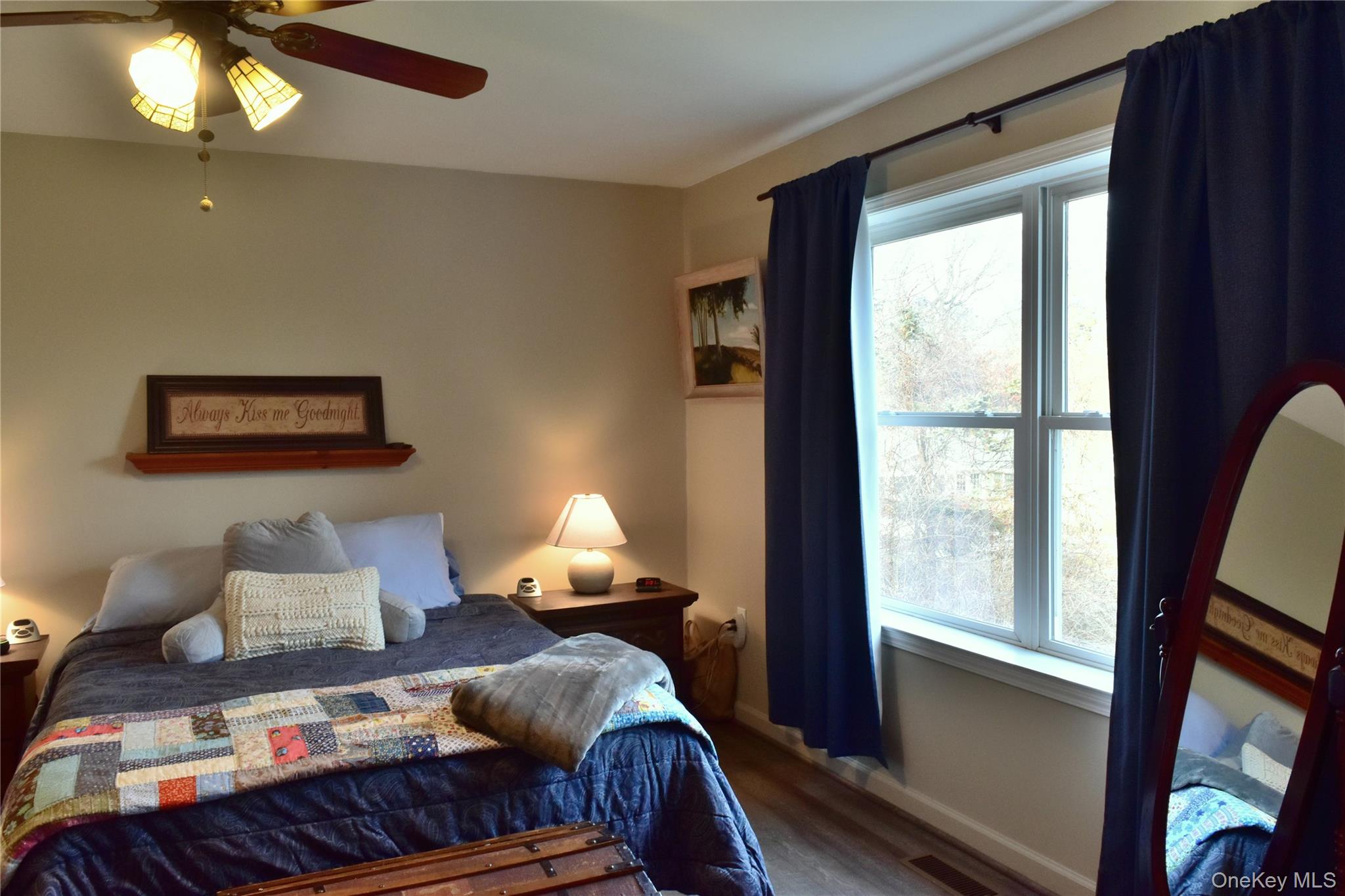 387 Cornwall Hill Road Patterson, NY 12563 - Photo 16 of 50 a bedroom with a bed and a lamp next to a window