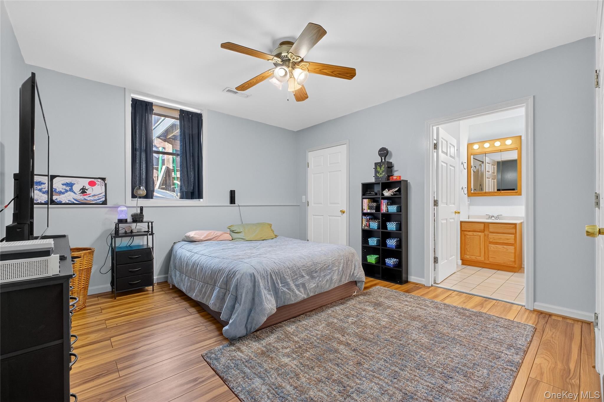 387 Cornwall Hill Road Patterson, NY 12563 - Photo 19 of 43 Apartment Bedroom featuring light wood finished floors, a ceiling fan, and ensuite bathroom