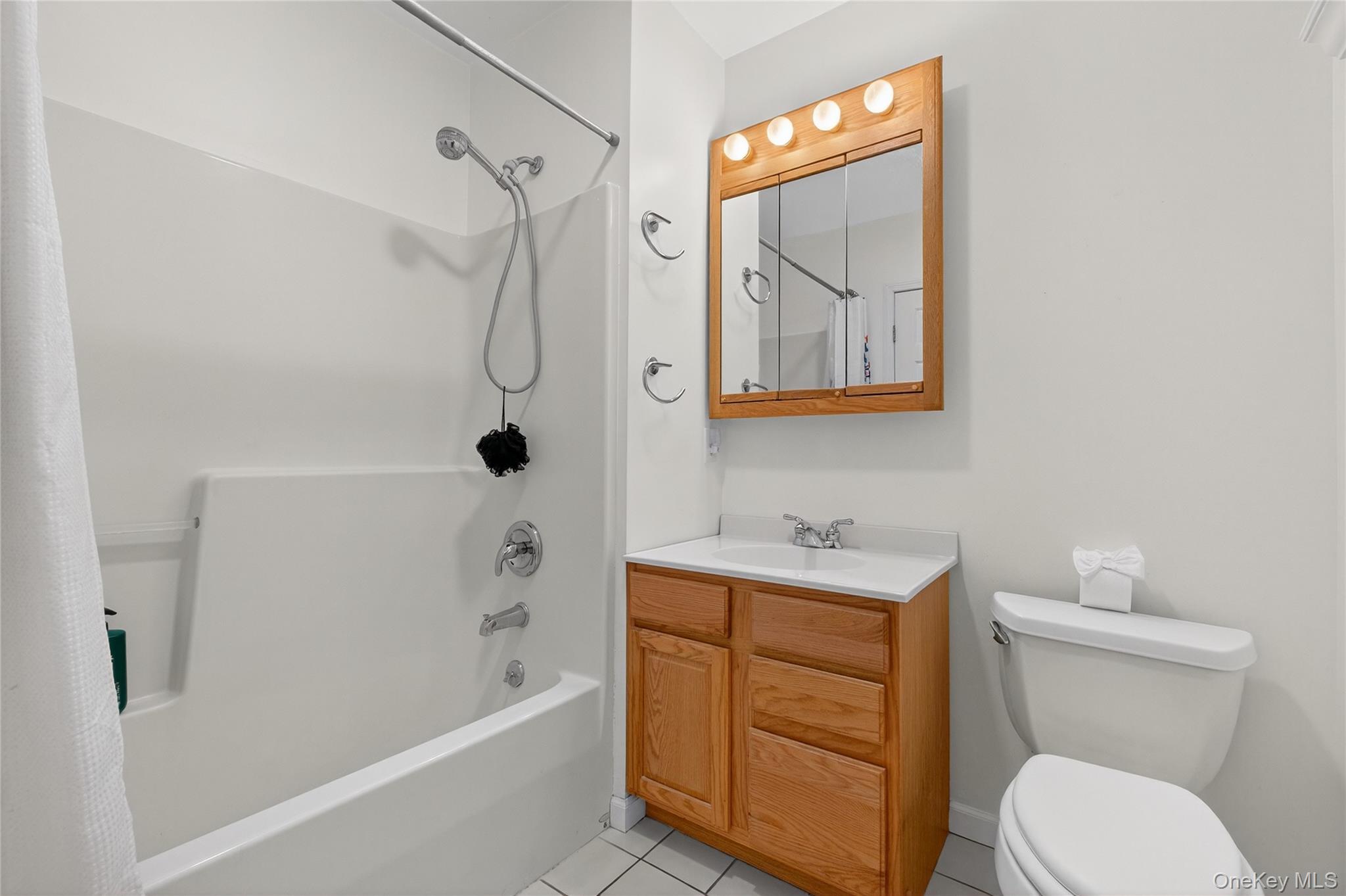 387 Cornwall Hill Road Patterson, NY 12563 - Photo 20 of 43 Apartment Full bath with shower / tub combo with curtain, vanity, and light tile patterned flooring