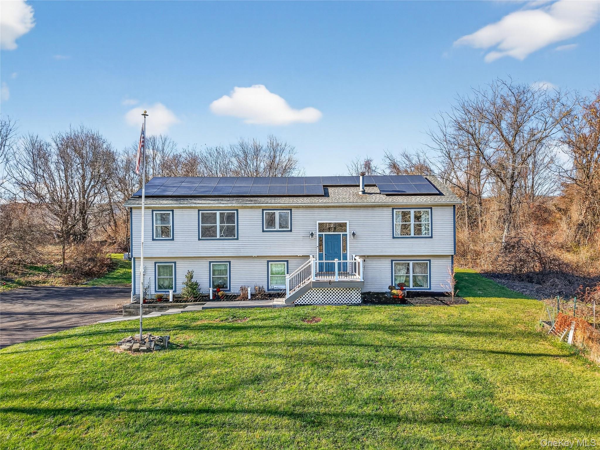 387 Cornwall Hill Road Patterson, NY 12563 - Photo 2 of 50 a front view of a house with a yard table and chairs