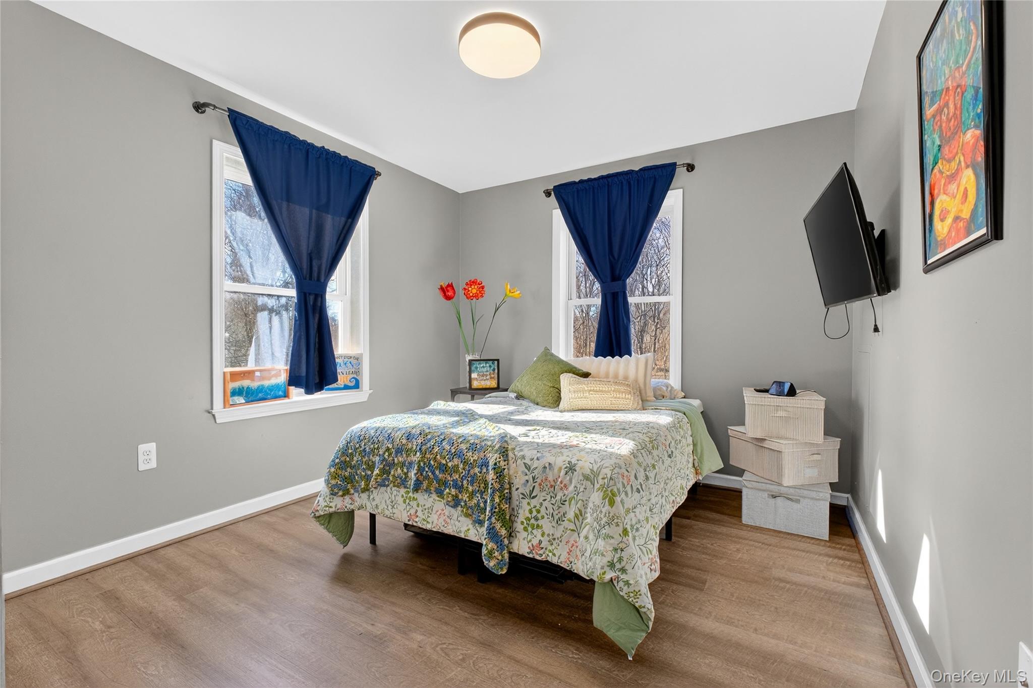 387 Cornwall Hill Road Patterson, NY 12563 - Photo 22 of 50 a bedroom with a bed and a flat screen tv