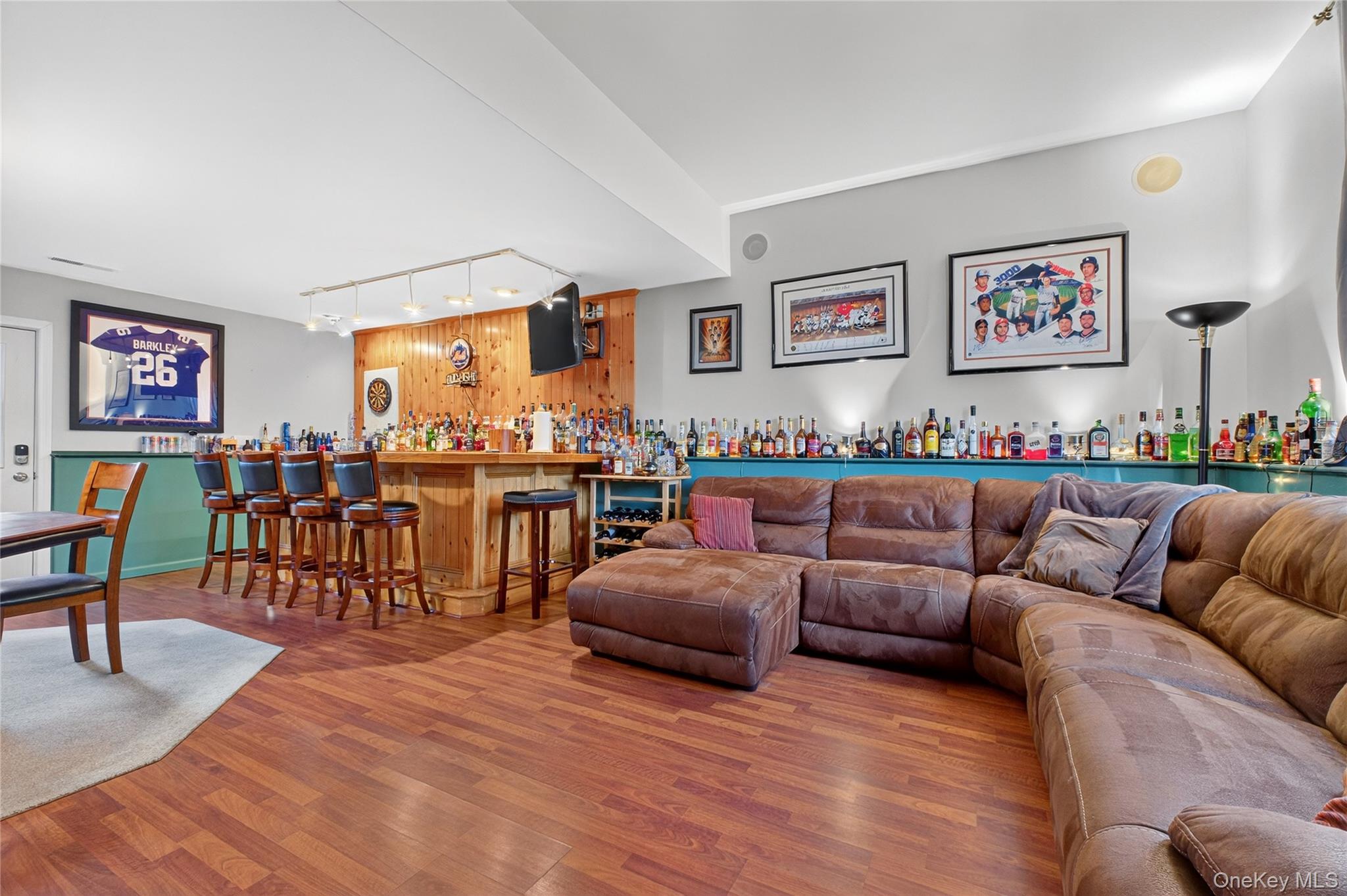 387 Cornwall Hill Road Patterson, NY 12563 - Photo 28 of 47 Living area w/custom bar featuring wood laminate finished floors and track lighting