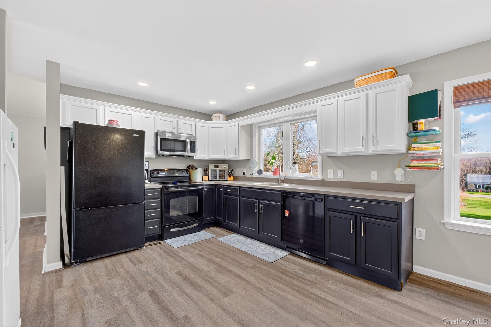 387 Cornwall Hill Road Patterson, NY 12563 - Photo 4 of 47 Upstairs Kitchen with white cabinets, black appliances