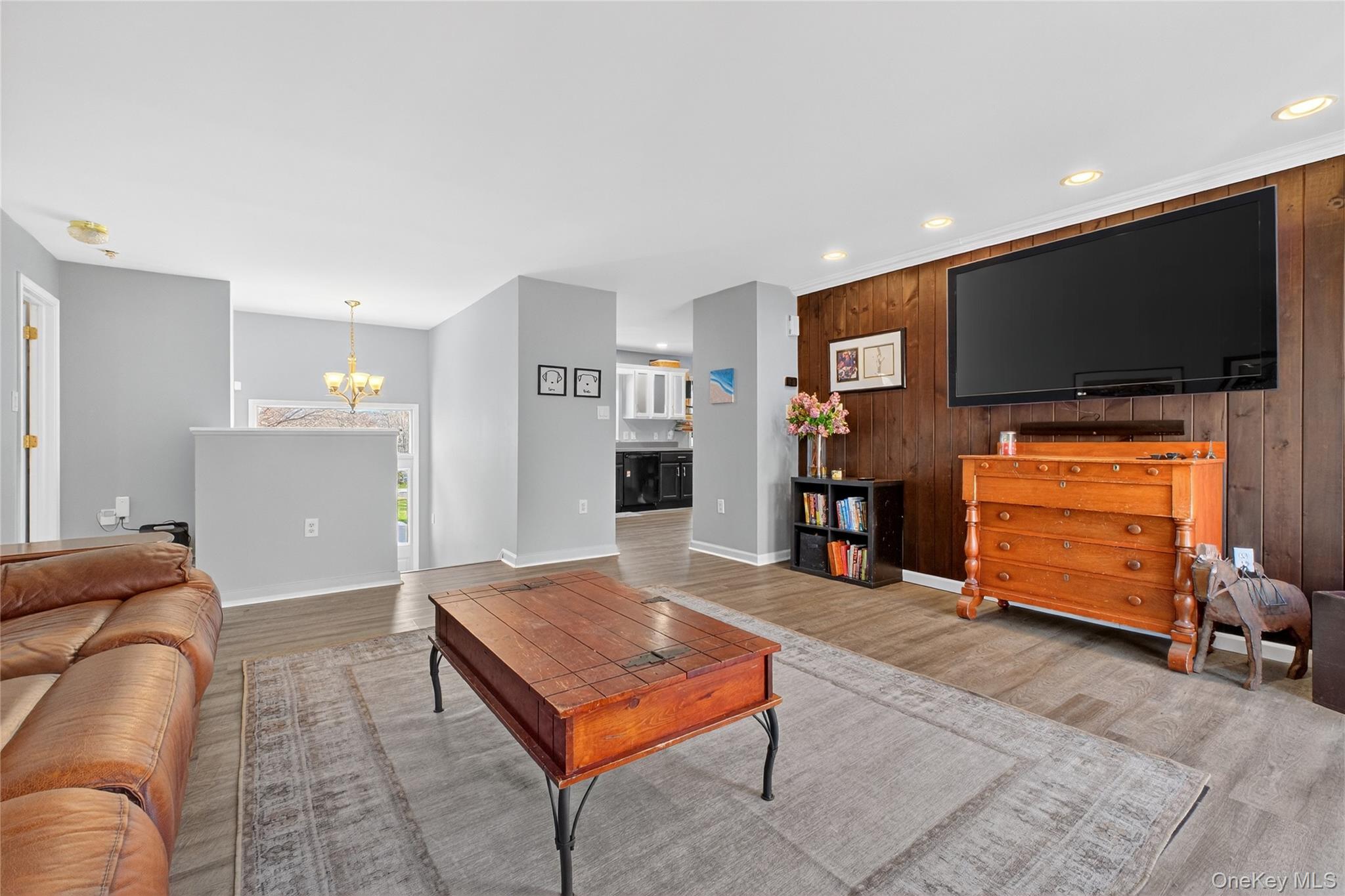 387 Cornwall Hill Road Patterson, NY 12563 - Photo 7 of 47 Living room featuring an accent wall, and wood look laminate floors
