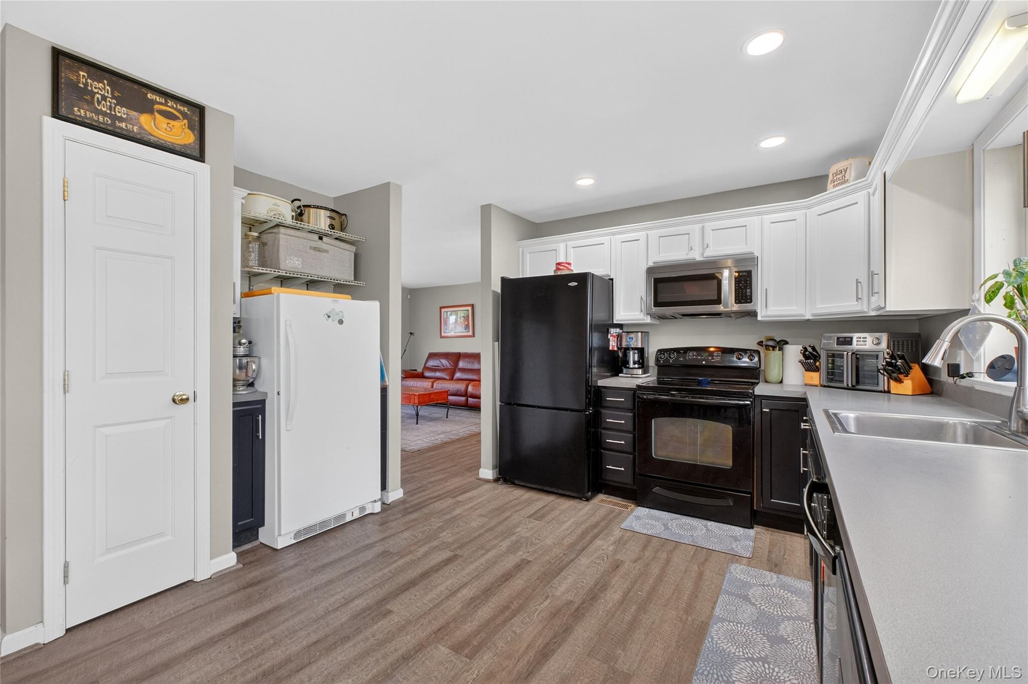 387 Cornwall Hill Road Patterson, NY 12563 - Photo 8 of 50 a kitchen with a refrigerator a stove and a sink