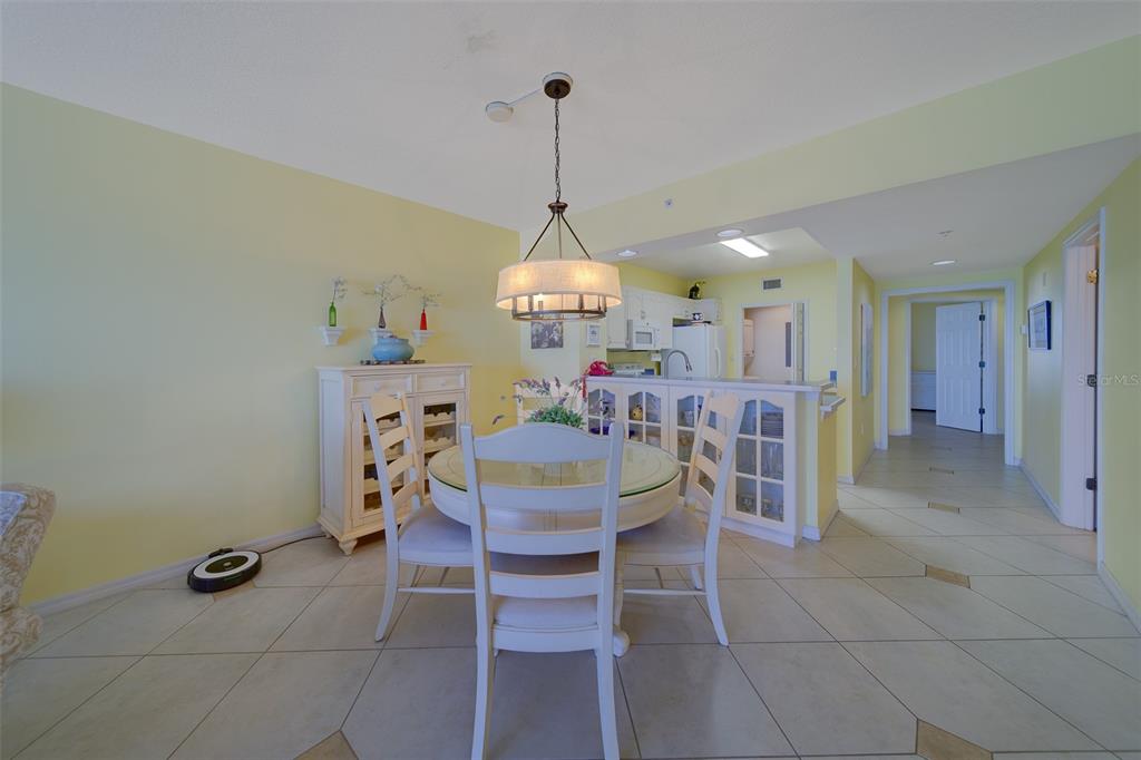 16450 Gulf Boulevard, Unit 564 North Redington Beach, FL 33708 - Photo 8 of 66 a view of a dining room and kitchen with furniture and a chandelier
