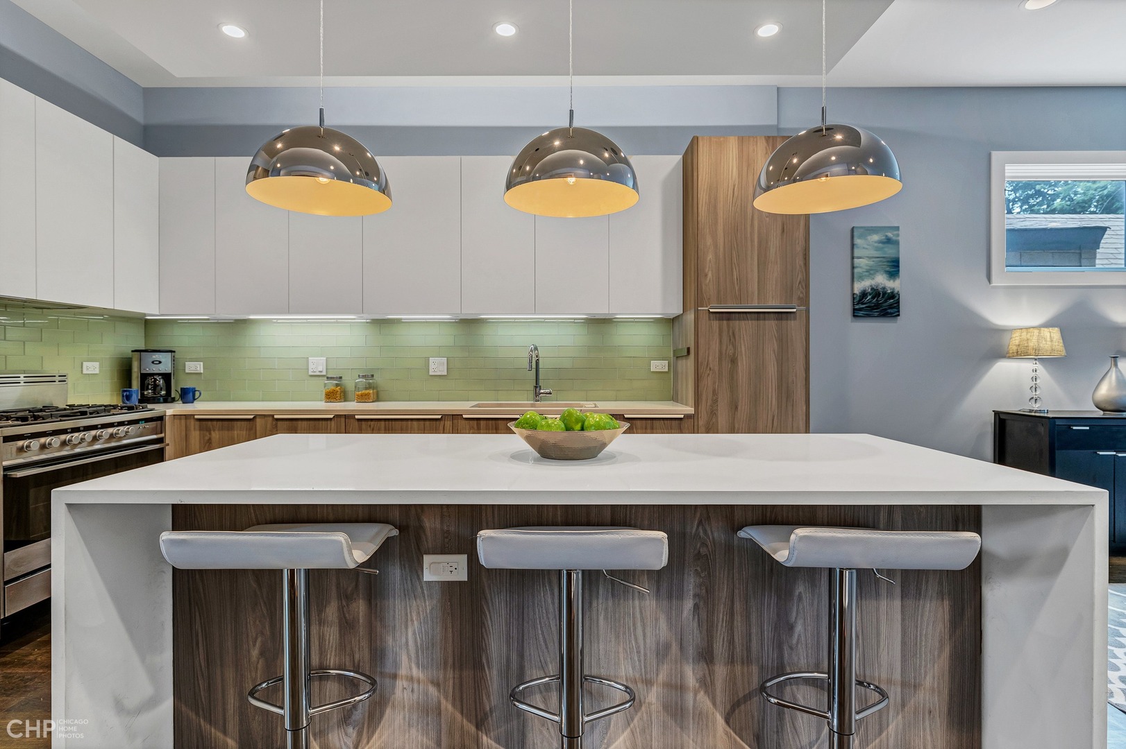 2030 West Rice Street, Unit 2 Chicago, IL 60622 - Photo 11 of 31 a kitchen with stainless steel appliances a table chairs and a refrigerator