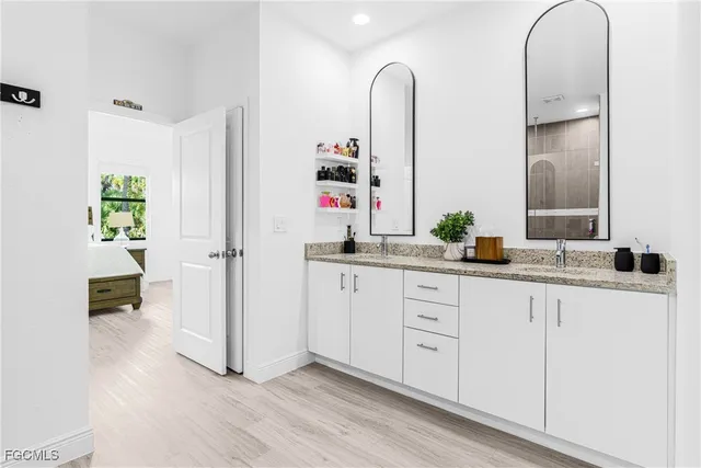 a bathroom with a double vanity sink and a mirror