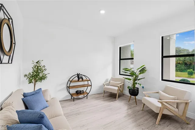 a living room with furniture and a potted plant