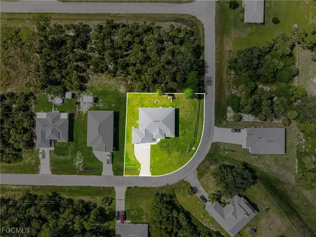 an aerial view of a residential houses with outdoor space and street view
