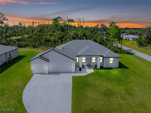 a aerial view of a house next to a big yard