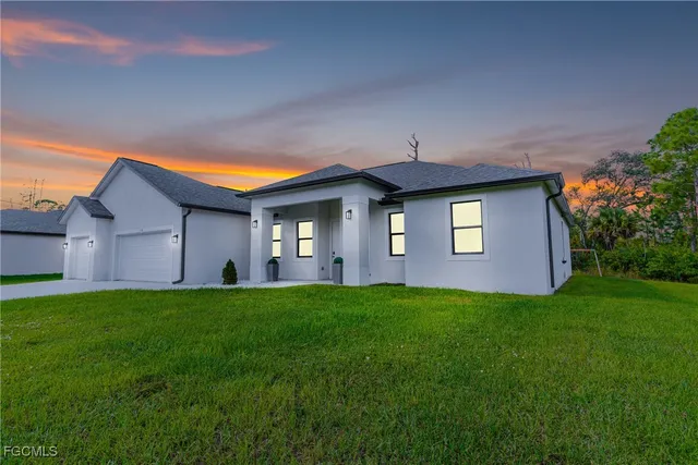 a front view of a house with a garden