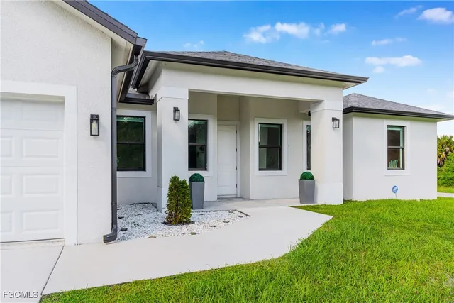 a front view of a house with garden