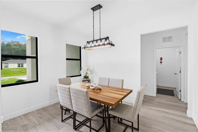 a view of a dining room with furniture wooden floor and a chandelier