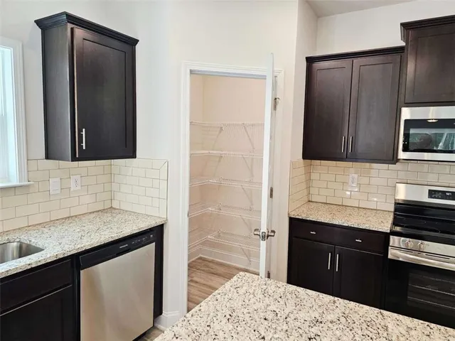 a kitchen with a sink stove and refrigerator