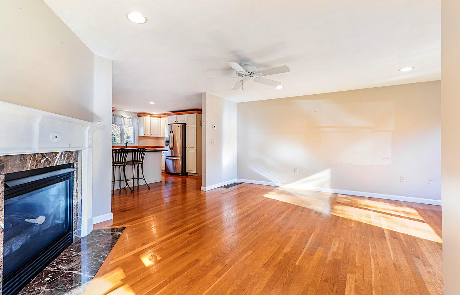 22 Weather Crescent Circle Mashpee, MA 02649 - Photo 5 of 29 a view of empty room with wooden floor and fireplace