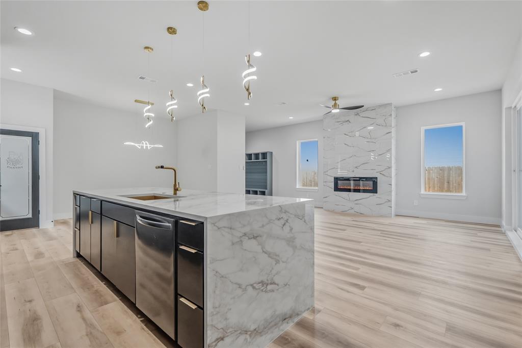 3914 Harlingen Street Dallas, TX 75212 - Photo 8 of 28 a kitchen with stainless steel appliances granite countertop a sink and stove top oven