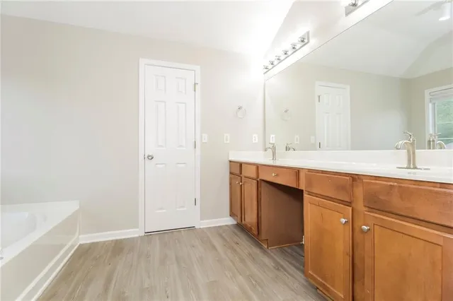 a bathroom with a sink a mirror and a bathtub