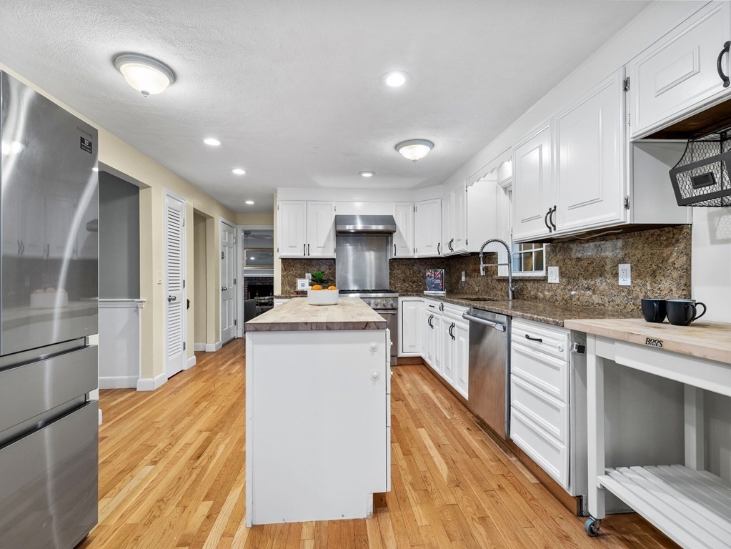 4 Woodside Road Framingham, MA 01701 - Photo 8 of 28 a kitchen with stainless steel appliances granite countertop a refrigerator a stove and a sink