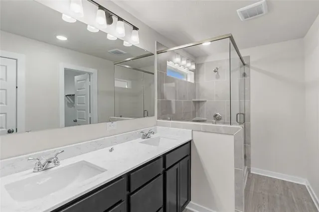 a bathroom with a sink double vanity mirror and a bathtub