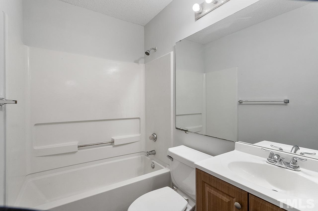 1241 University Court, Unit 2 Raleigh, NC 27606 - Photo 11 of 34 a bathroom with a sink toilet vanity and tub