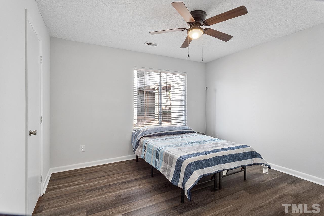 1241 University Court, Unit 2 Raleigh, NC 27606 - Photo 17 of 34 a bedroom with a bed and a ceiling fan