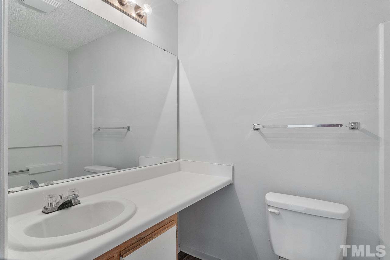1241 University Court, Unit 2 Raleigh, NC 27606 - Photo 19 of 34 a bathroom with a sink a toilet and a mirror