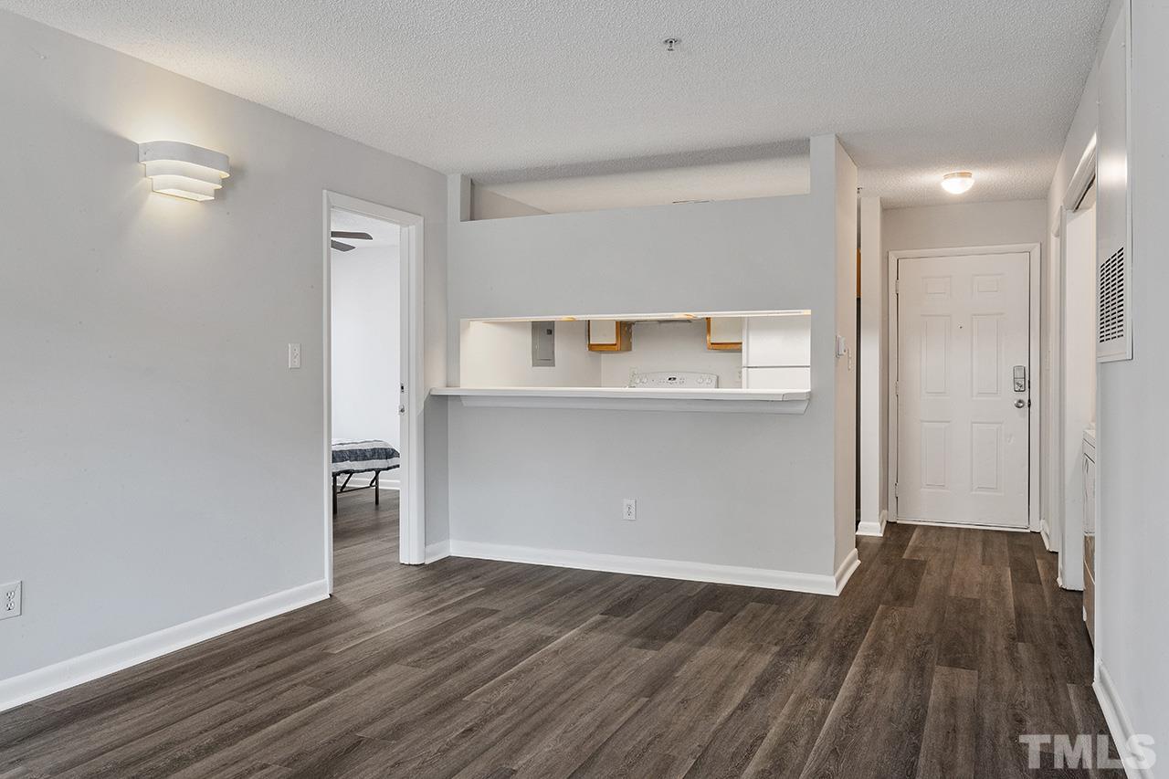1241 University Court, Unit 2 Raleigh, NC 27606 - Photo 22 of 34 a view of a kitchen with wooden floor and a refrigerator