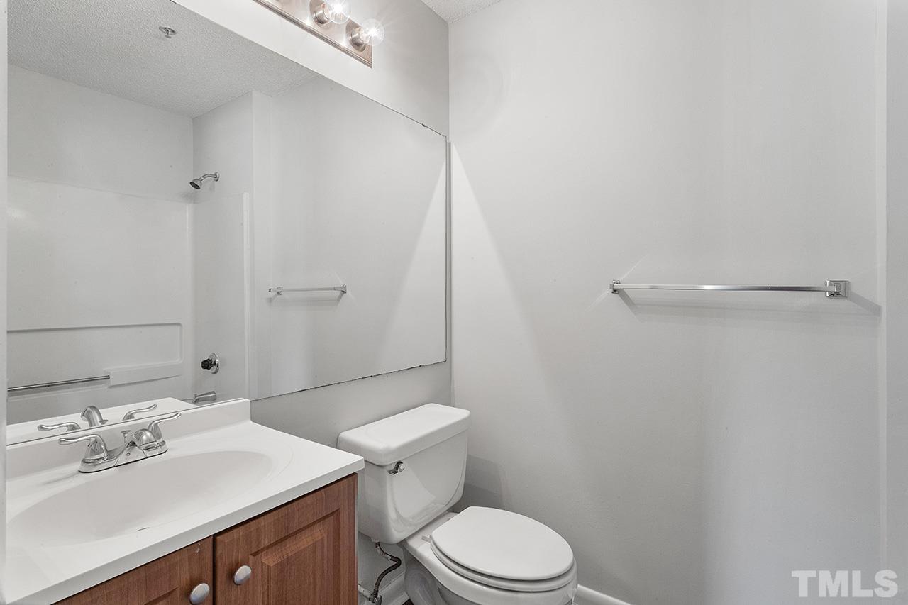 1241 University Court, Unit 2 Raleigh, NC 27606 - Photo 28 of 34 a bathroom with a sink a toilet and shower
