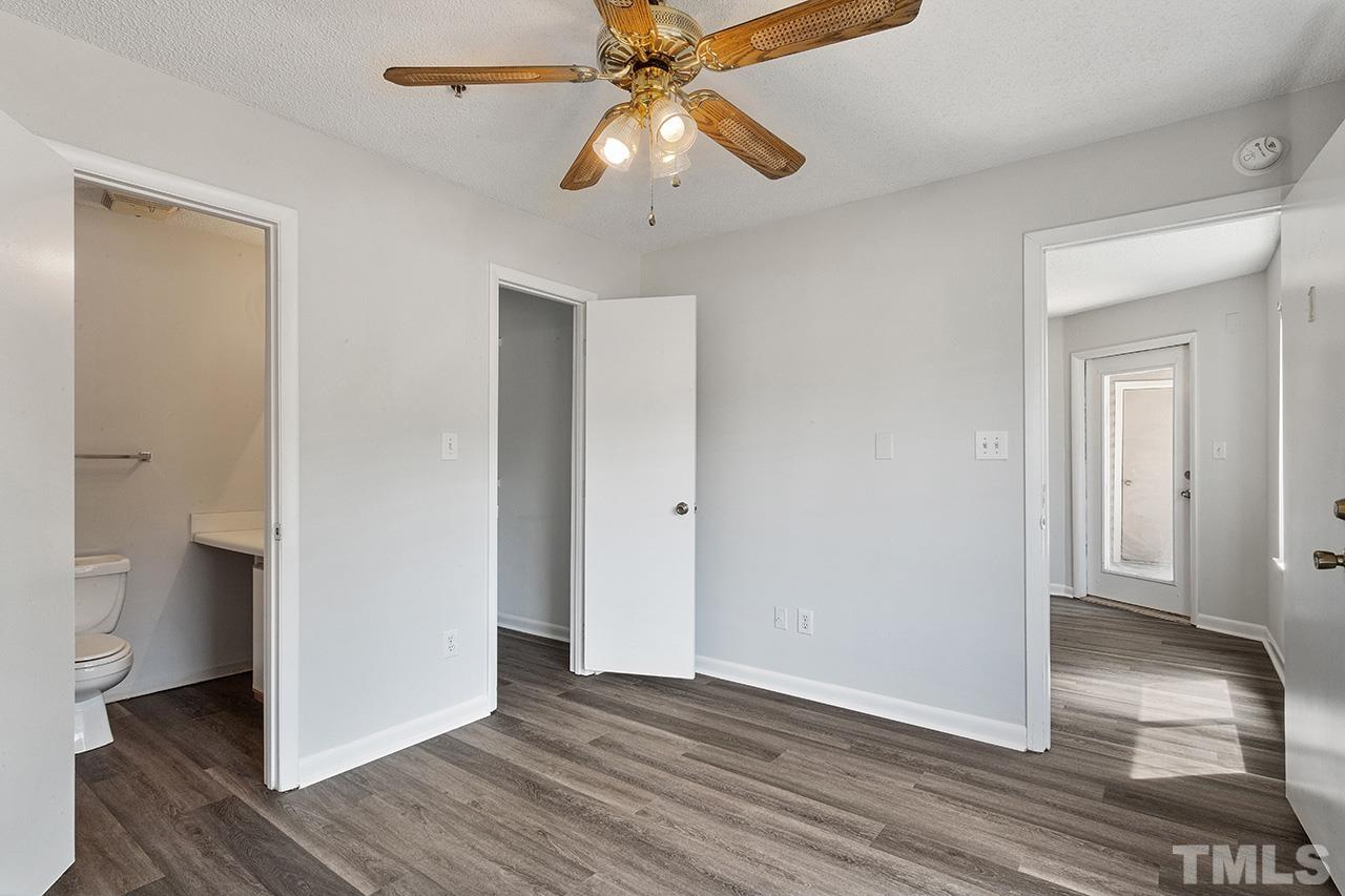 1241 University Court, Unit 2 Raleigh, NC 27606 - Photo 30 of 34 a view of an empty room with wooden floor and a ceiling fan