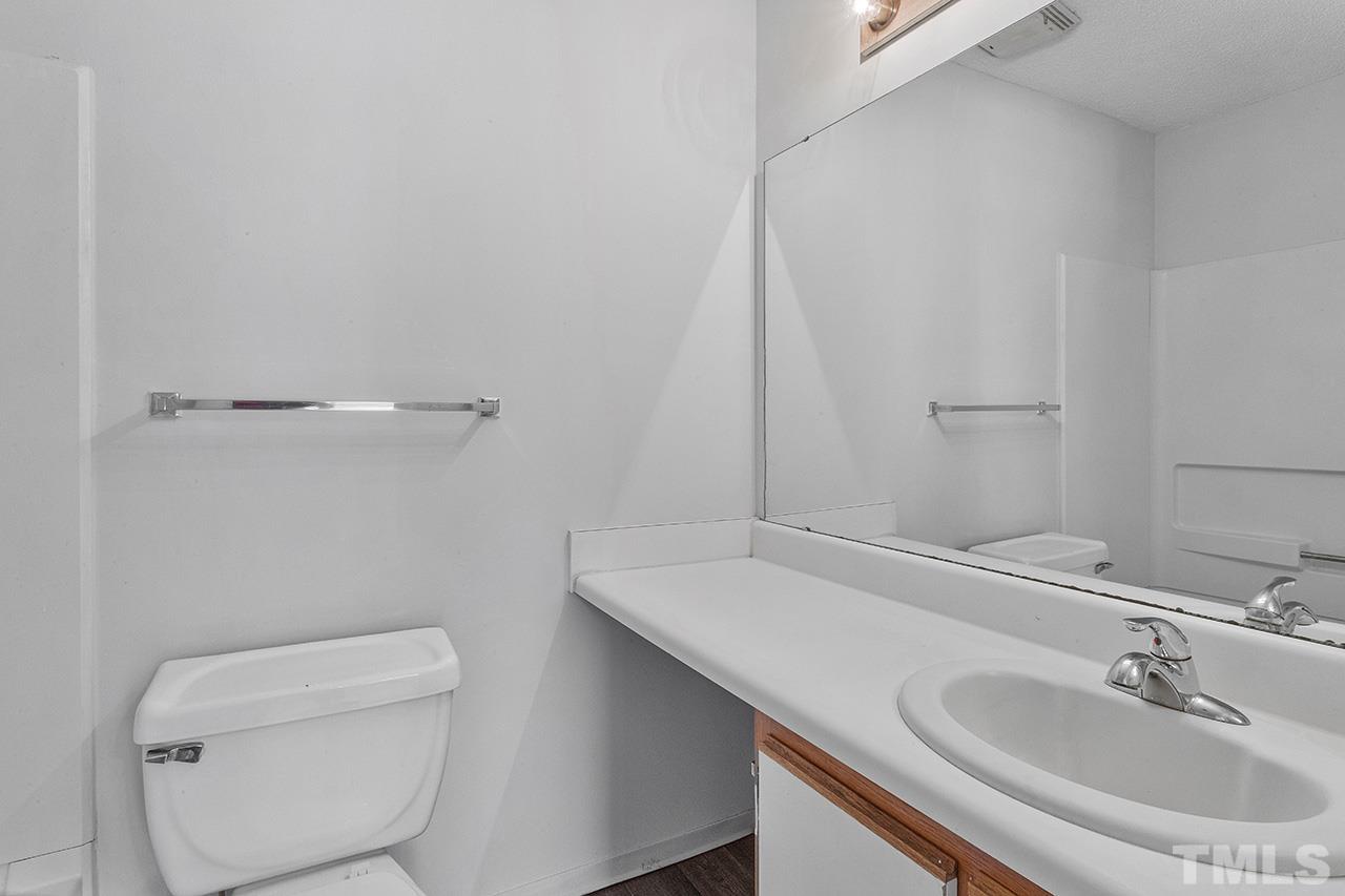 1241 University Court, Unit 2 Raleigh, NC 27606 - Photo 31 of 34 a bathroom with a sink a toilet and a mirror