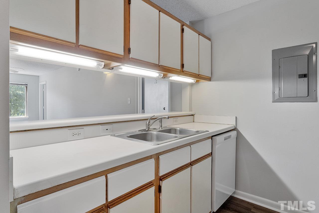 1241 University Court, Unit 2 Raleigh, NC 27606 - Photo 5 of 34 a kitchen with a sink and cabinets