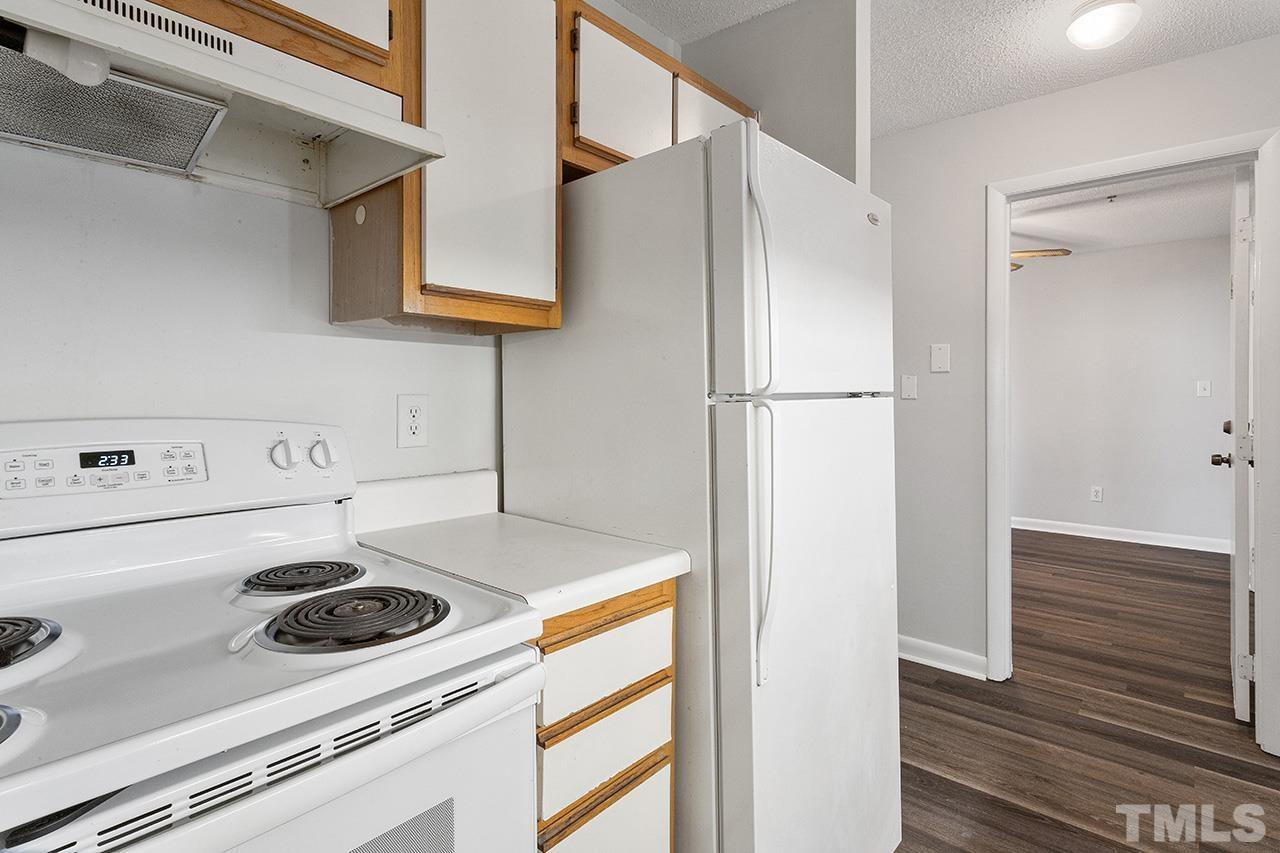 1241 University Court, Unit 2 Raleigh, NC 27606 - Photo 7 of 34 a kitchen with a refrigerator and a sink