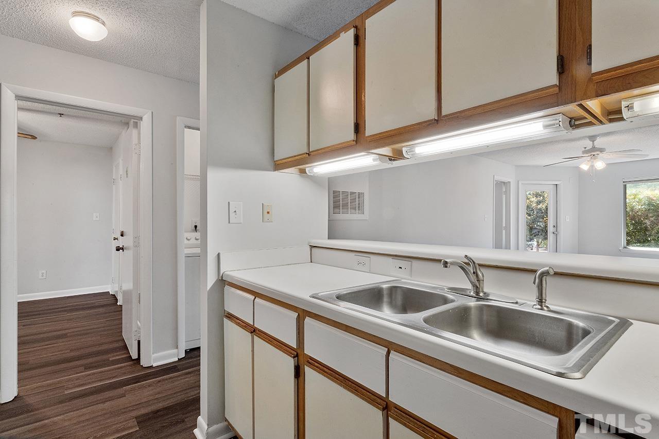 1241 University Court, Unit 2 Raleigh, NC 27606 - Photo 8 of 34 a kitchen with a sink and cabinets